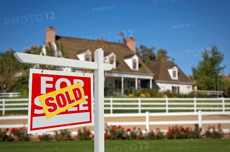 Sold home for sale real estate sign in front of new house