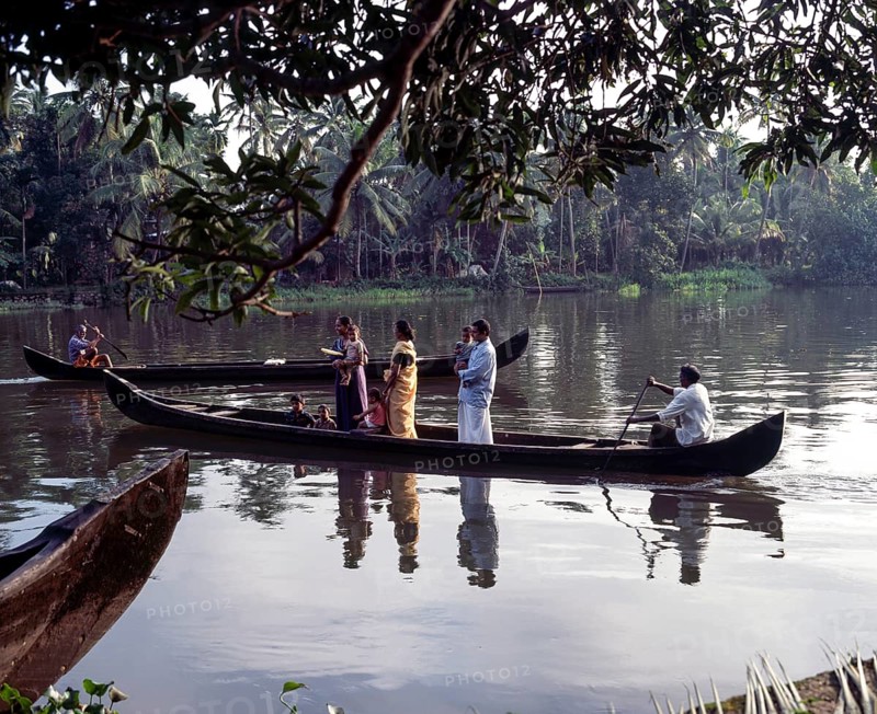 People being taken in a boat across the back waters of Alappuzha or Alleppey in Kerala