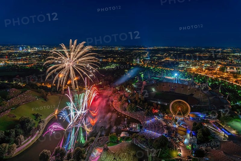 Fireworks over Munich from a high position. The illuminated Olympic Park at night with view from the Olympic Tower
