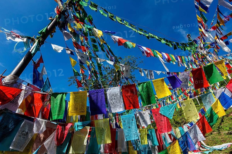 Buddhist prayer flags lungta with Om Mani Padme Hum Buddhist mantra prayer meaning Praise to the Jewel in the Lotus on kora around Tsuglagkhang complex