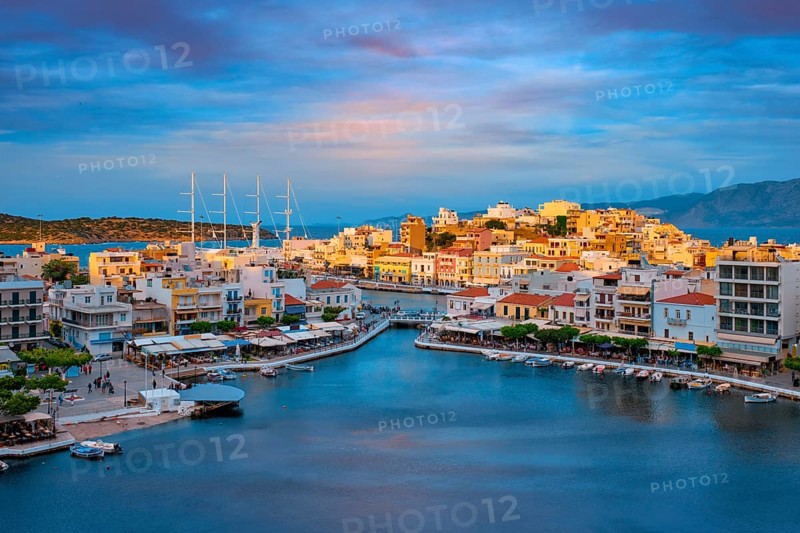 Beautiful Agios Nikolaos town on lake Voulismeni on sunset. Lasithi region of Crete island