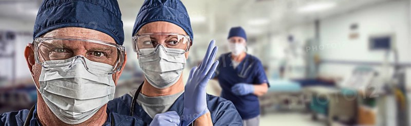 Team of female and male doctors or nurses wearing personal protective equipment in hospital emergency room
