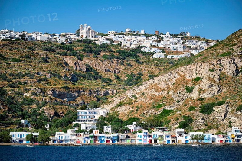 Klima and Plaka villages with whitewhashed traditional houses and orthodox church and windmills on Milos island