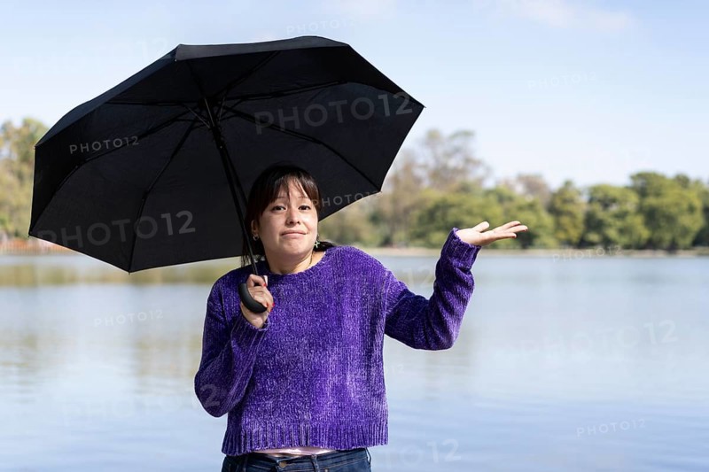 Latin woman with umbrella on a sunny day