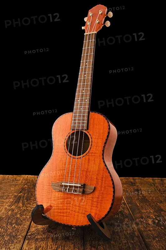 Ukulele Hawaiian guitar music instrument on wooden backgroun close up