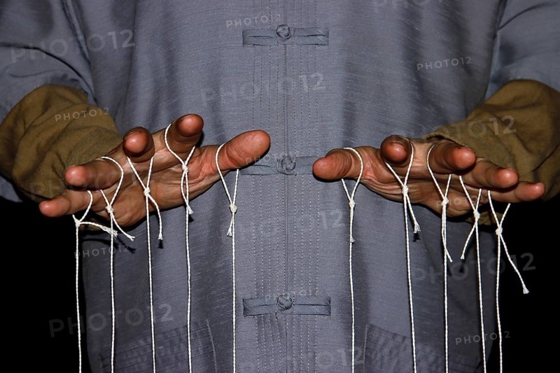 String-pulling puppeteer with Chinese shirt