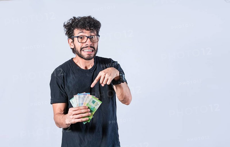Man pointing at the money in his hand