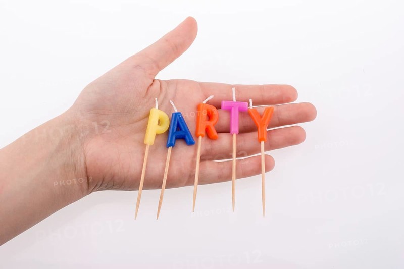 Color candles in hand on sticks write the word party