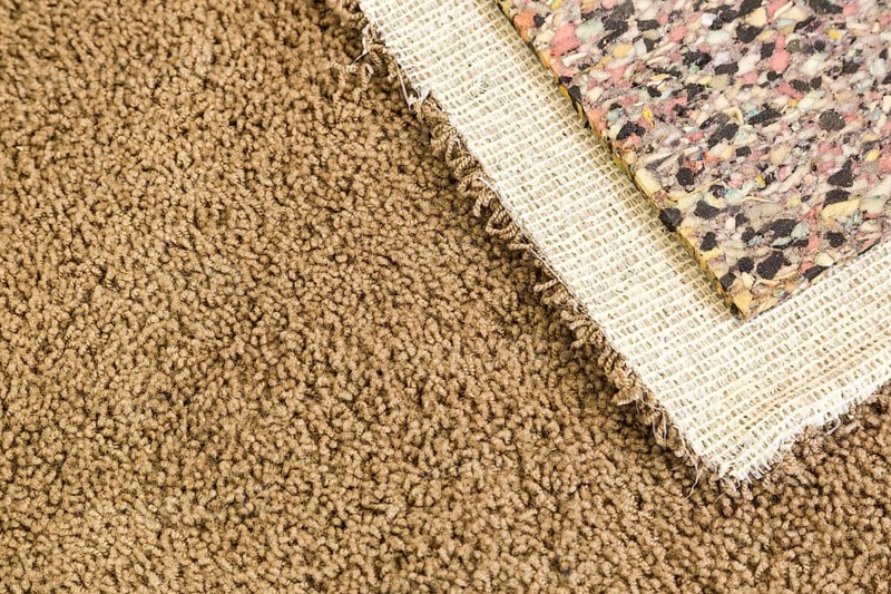 Pulled back carpet and underlay in room of house