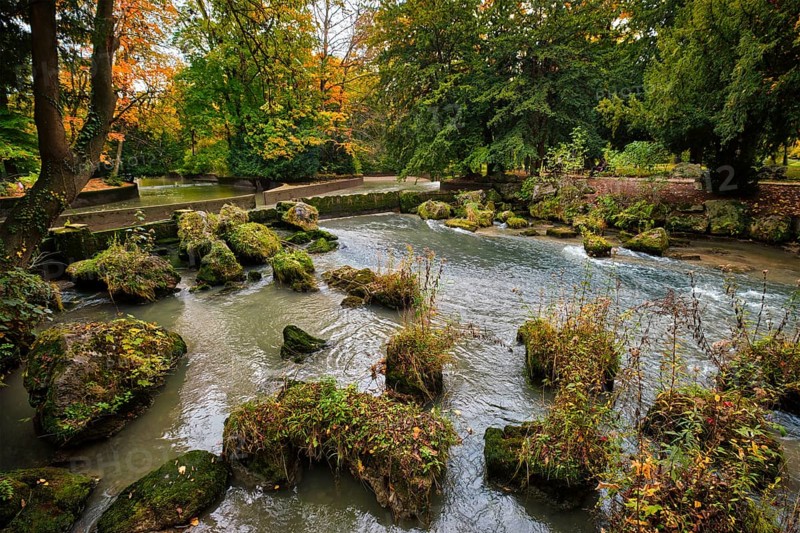 Munich English garden Englischer garten park and Eisbach river with artificial waterfall
