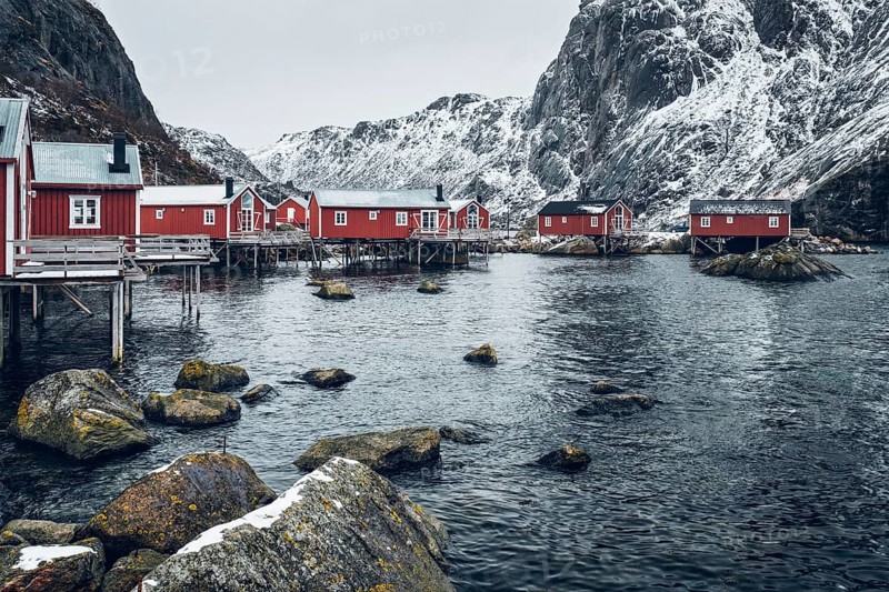 Nusfjord authentic traditional fishing village with traditional red rorbu houses in winter in Norwegian fjord. Lofoten islands