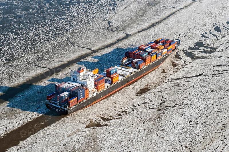 Container ship on the Elbe in ice