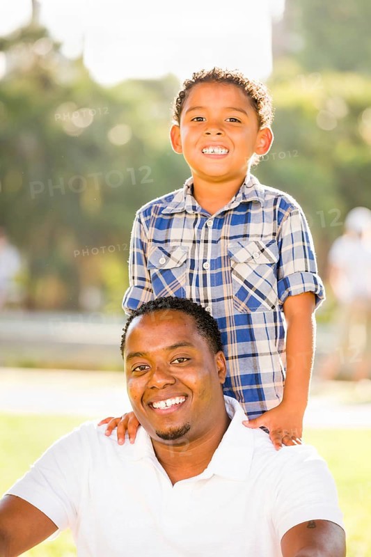 Happy african american father and mixed-race son playing at the park