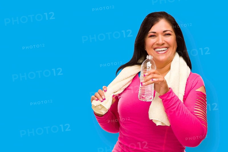 Middle aged hispanic woman in workout clothes with towel and water bottle against A cyan blue background