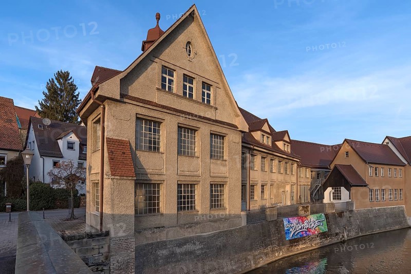 Historic main building of a former valve factory in the evening light