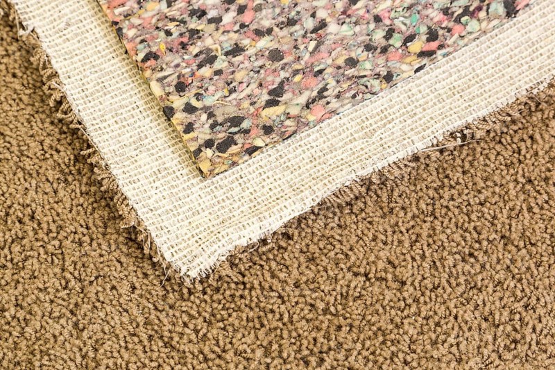 Pulled back carpet and underlay in room of house