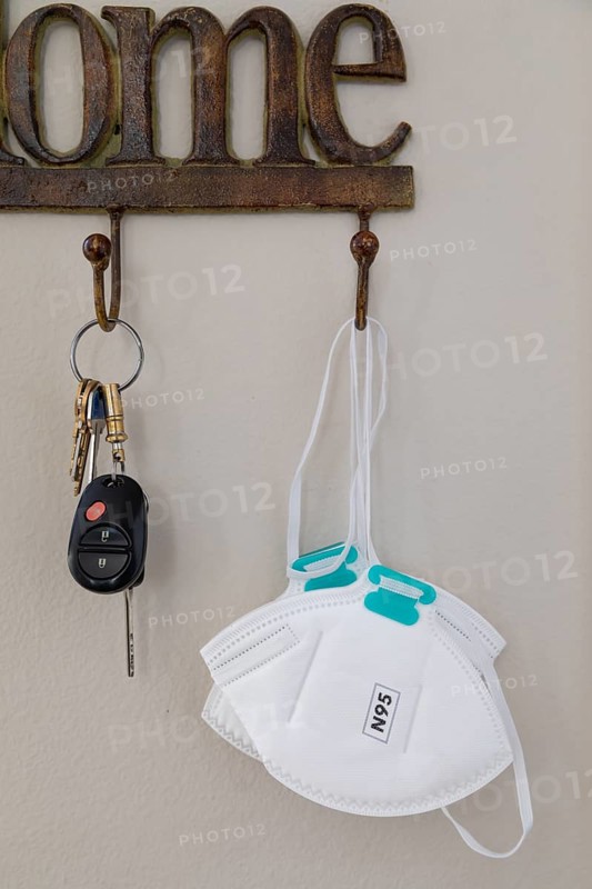 Home key hanger rack next to door with keys and medical face mask during coronavirus pandemic