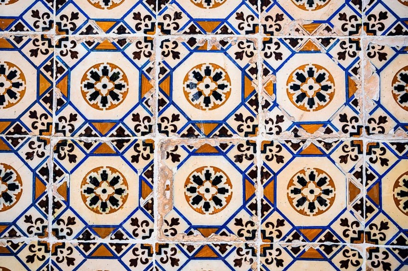 Old Portuguese tiles called azulejo found on the wall in Sesimbra