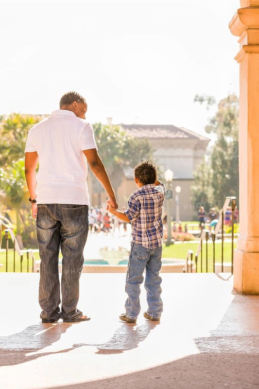 Happy african american father and mixed-race son walking at the park