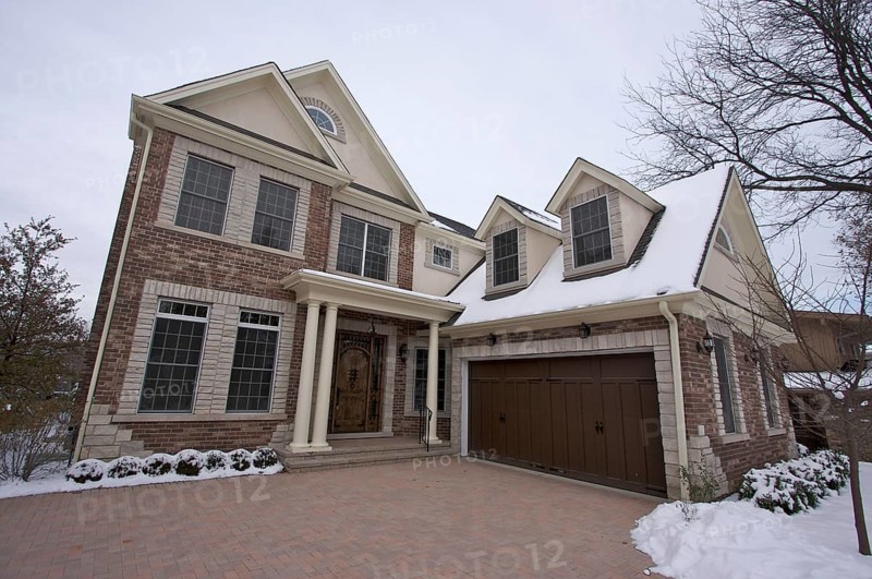 Majestic newly constructed home facade on a blustry winter day