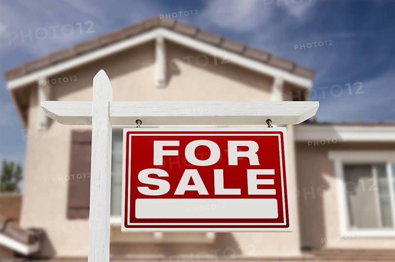 Home for sale real estate sign and house