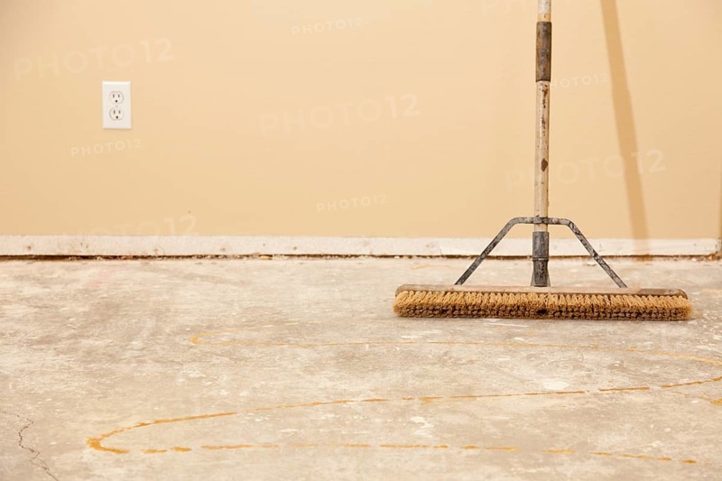 Blank concrete house floor with broom ready for flooring installation
