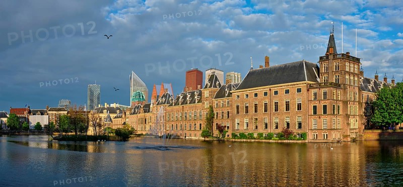 Panorama of the Binnenhof House of Parliament and the Hofvijver lake with downtown skyscrapers in background