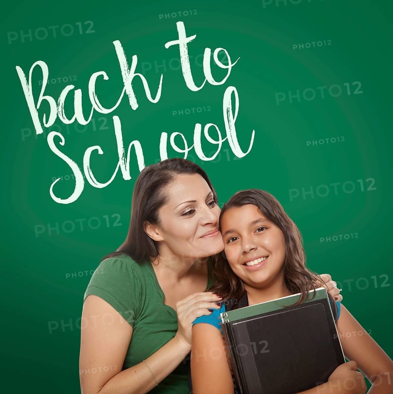 Back to school written on chalk board behind proud hispanic mother and daughter student