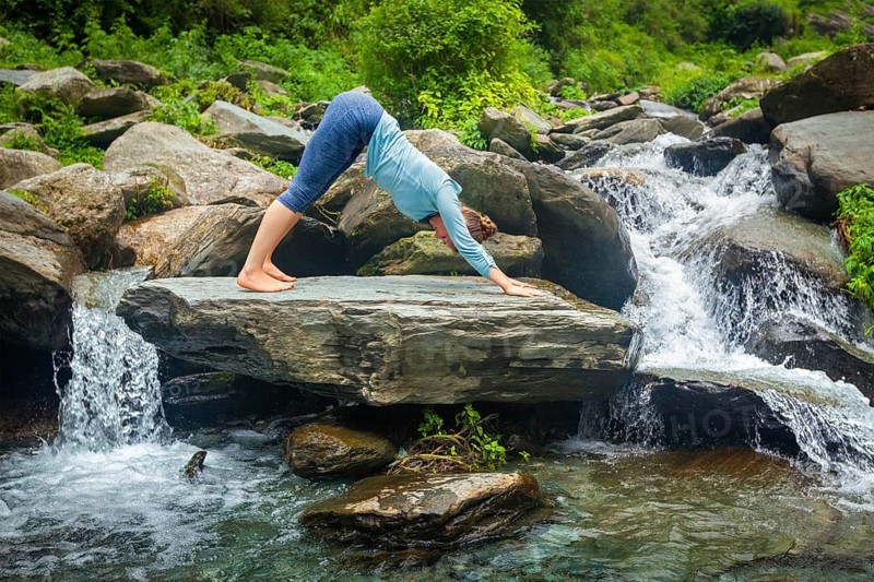 Young sporty fit woman doing yoga asana Adho mukha svanasana