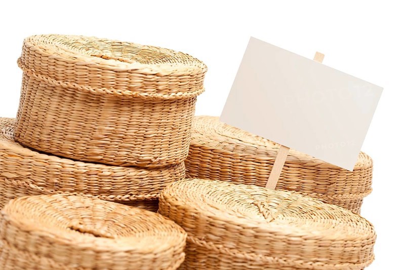 Various sized wicker baskets with blank sign isolated on white