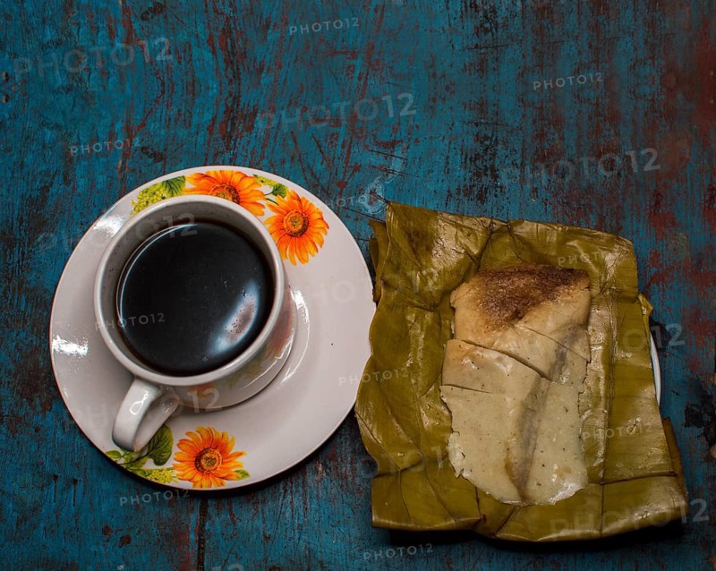 Stuffed tamale served on wooden table
