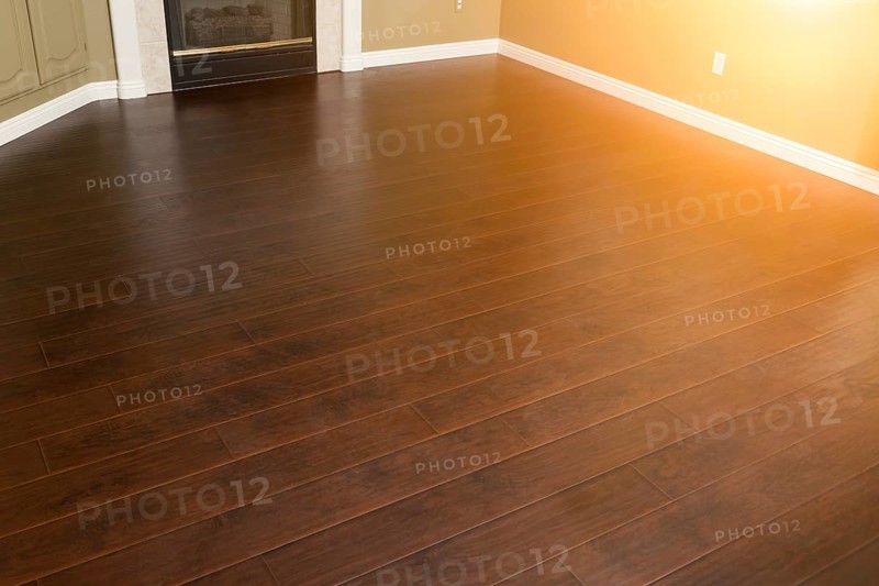 Beautiful newly installed brown laminate flooring and baseboards in home