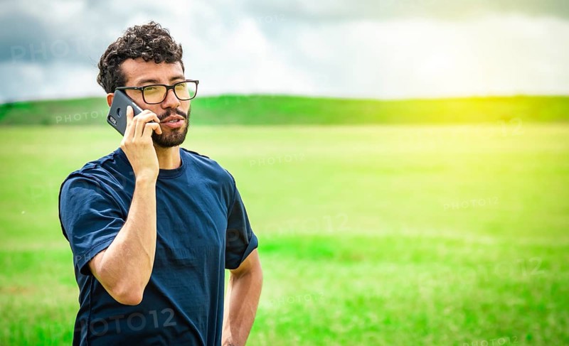 Man calling on the phone in the field