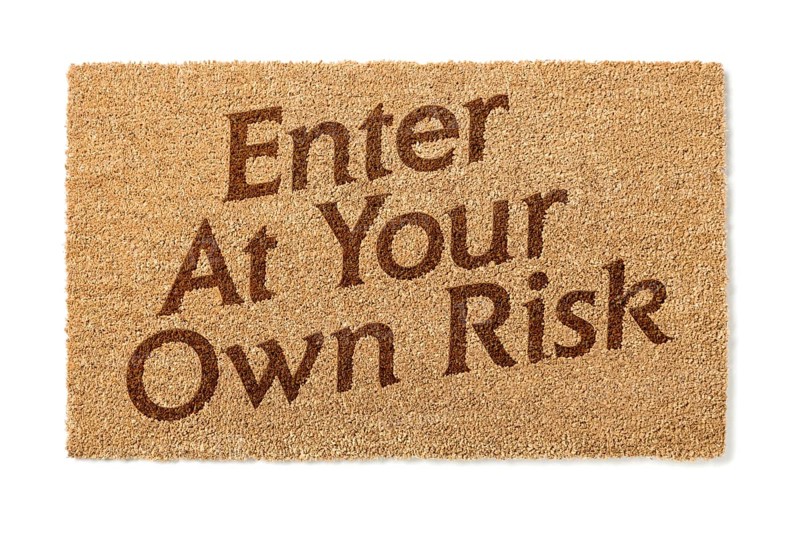 Enter at your own risk welcome mat isolated on A white background