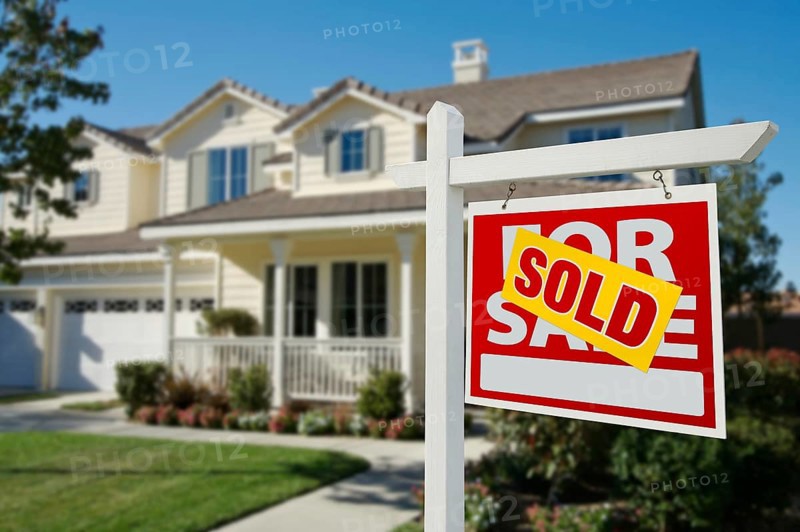 Sold home for sale real estate sign in front of new house