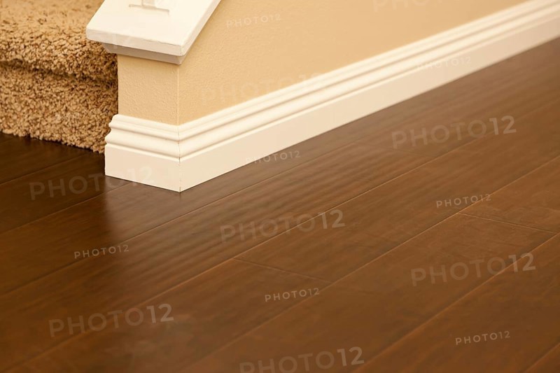 Beautiful newly installed brown laminate flooring and baseboards in home