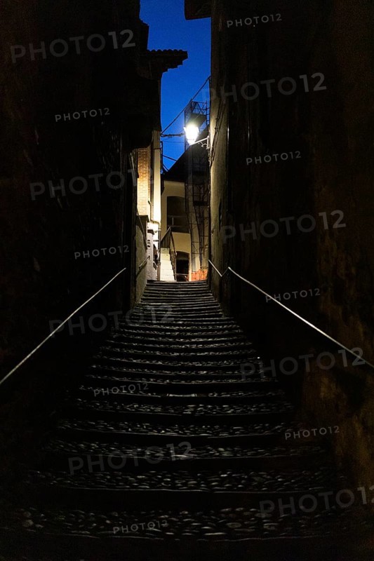 Narrow dark alley with stairs in Cannobio
