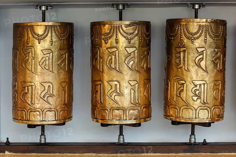 Metal buddhist prayer wheels with buddhist mantra Om mani padme hum meaning Praise to the Jewel in the Lotus in Tsuglagkhang complex in Dalai Lama residence. Mcleodganj