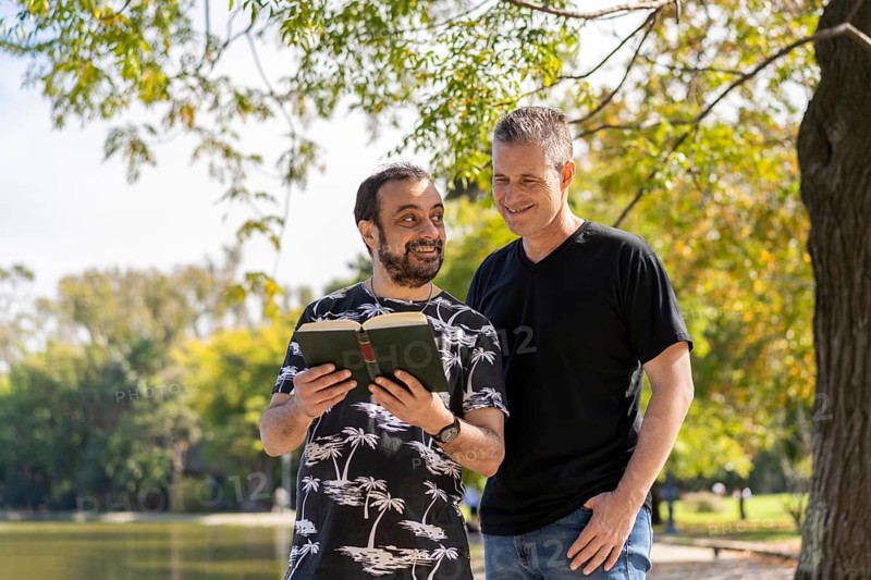 Couple of mature men reading in a lake