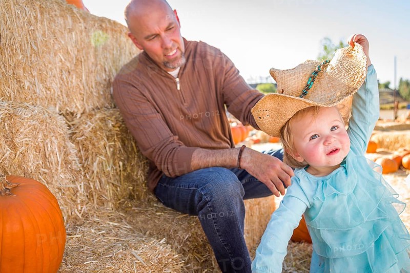 Adorable young family enjoys a day at the pumpkin patch