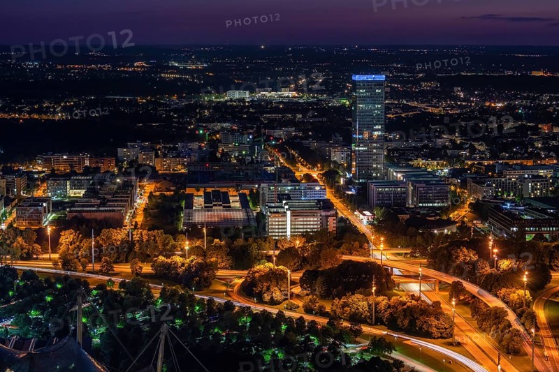 Large city with offices and apartment blocks at night from an elevated position