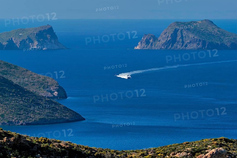 Speeding speed boat catamaran ferry vessel in Aegean sea near Milos island on summer day in Greece