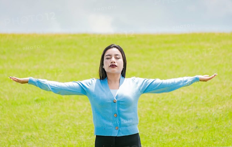 A girl spreading her arms in the field
