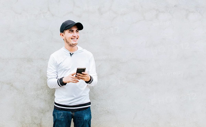 Handsome guy happy with his cell phone
