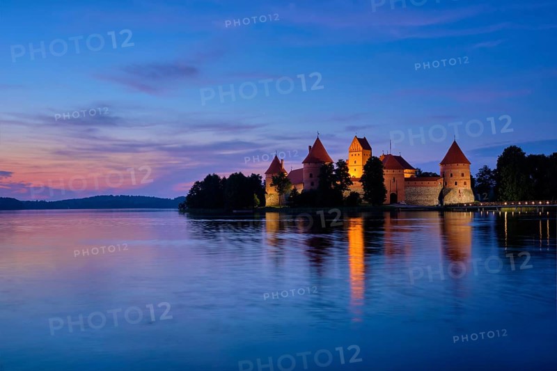 Night view of Trakai Island Castle in lake Galve illuminated in the evening