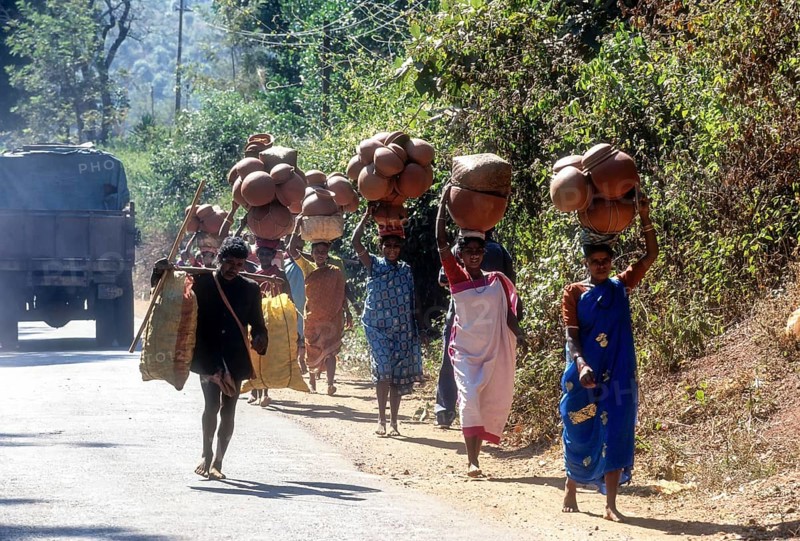 Tribal woman carrying pots on head to weekly market at Sunkarametta in Araku Valley near Visakhapatanam