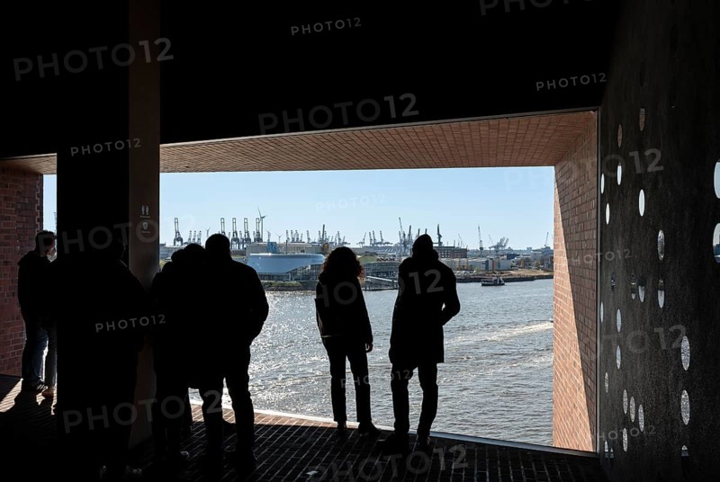 Visitors standing at the window of the public viewing platform