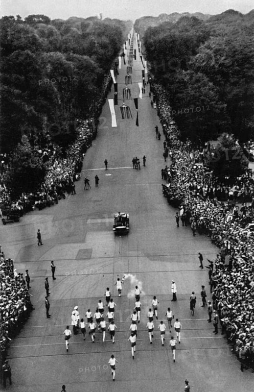 The relay with the Olympic flame on the way to the stadium