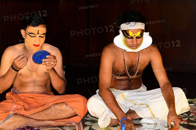 Kathakali dancer putting on make-up