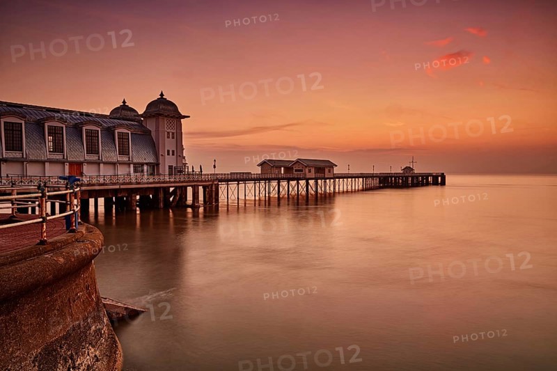View of Victorian pier in seaside town at sunrise